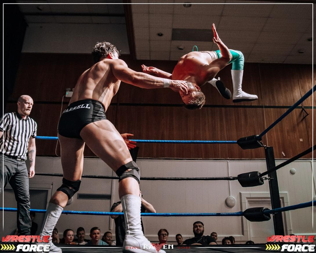 Two Wrestlers in the ring, one of them is doing a backflip